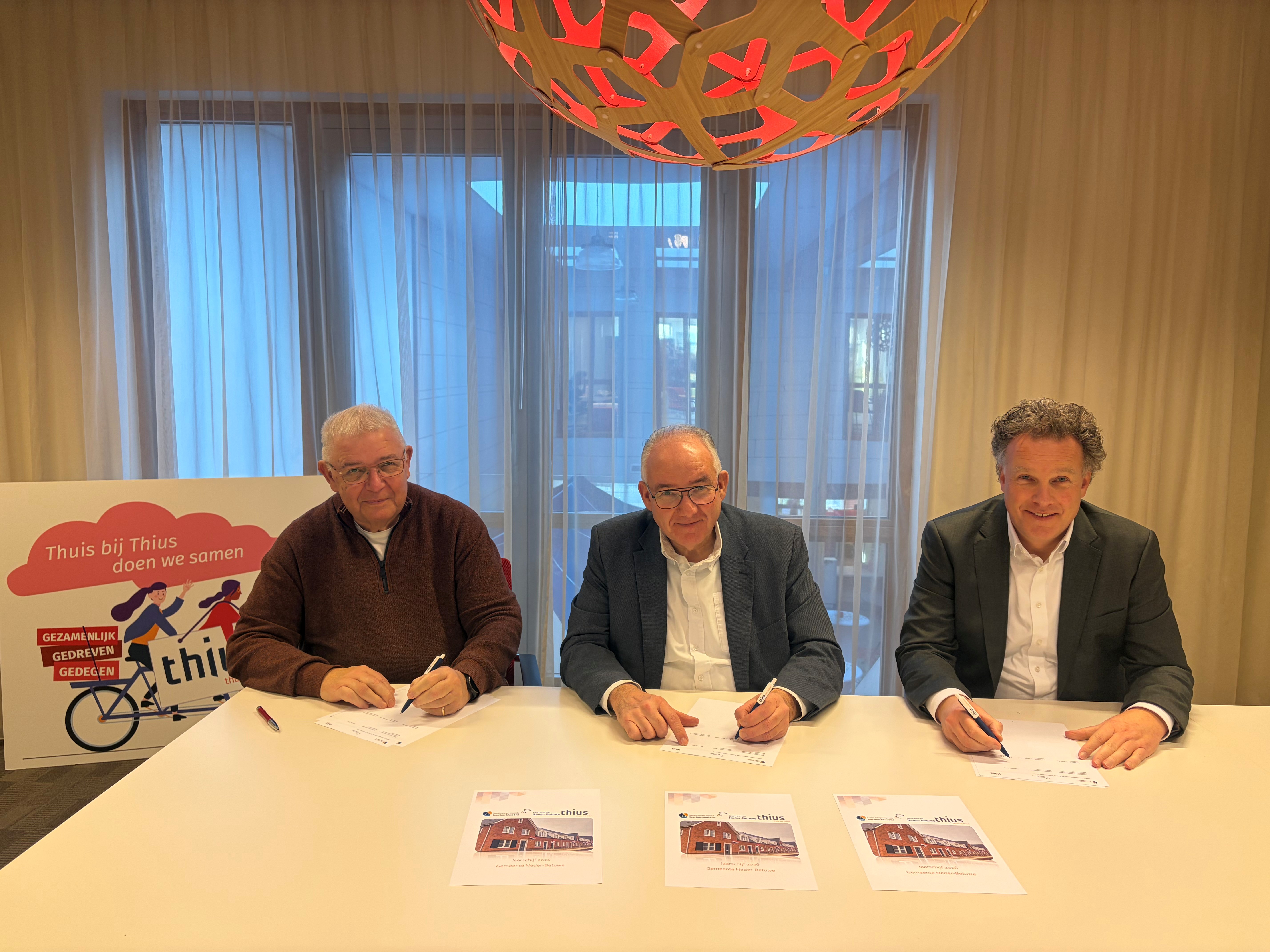 Wethouder Nees van Wolfswinkel (gemeente Neder-Betuwe), René Wiersema (directeur Thius) en de Huurders Belangen Organisatie Buren, Neder-Betuwe en Tiel ondertekenen de de gezamenlijke prestatieafspraken voor 2026 en 2027.
